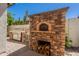 Outdoor kitchen area with pizza oven, stainless steel grill, and brick paving at 3971 E Leo Pl, Chandler, AZ 85249