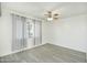 Bedroom with a ceiling fan, window with blinds and curtains, neutral walls and new flooring at 4628 W Solano S Dr, Glendale, AZ 85301
