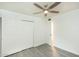 Bedroom with ceiling fan, new flooring, a double closet, and neutral walls and white trim at 4628 W Solano S Dr, Glendale, AZ 85301