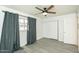 Bedroom with a ceiling fan, window with blinds and curtains, and large closet at 4628 W Solano S Dr, Glendale, AZ 85301