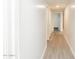 Long hallway with new gray flooring and neutral walls, recessed lighting and white trim at 4628 W Solano S Dr, Glendale, AZ 85301