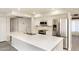 Kitchen featuring a large island with quartz countertops and stainless appliances at 4628 W Solano S Dr, Glendale, AZ 85301