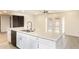A kitchen with a large island, double sink, white cabinetry and stainless steel appliances at 4628 W Solano S Dr, Glendale, AZ 85301