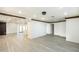 Spacious living area with wood beam ceilings, light floors, and a view into the kitchen at 4628 W Solano S Dr, Glendale, AZ 85301