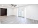 Open-concept living room with new gray flooring, neutral walls and white trim, and large french doors at 4628 W Solano S Dr, Glendale, AZ 85301