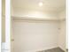 Clean, white walk-in closet with rod for hanging, ready for your personalized organization and wardrobe at 4628 W Solano S Dr, Glendale, AZ 85301