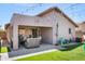 Inviting covered back patio with pavers, artificial turf and stylish patio furniture under festive string lights at 4704 E Melinda Ln, Phoenix, AZ 85050