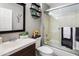 Cozy bathroom featuring a vanity, tiled shower, and a decorative mirror at 4704 E Melinda Ln, Phoenix, AZ 85050