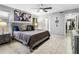 Comfortable bedroom with tile flooring, large bed, ceiling fan, and neutral color palette at 4704 E Melinda Ln, Phoenix, AZ 85050