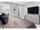 Cozy bedroom with ample closet space, dresser with TV, and relaxing atmosphere at 4704 E Melinda Ln, Phoenix, AZ 85050