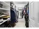 Walk-in closet with organized shelving, hanging racks, and a full-length mirror at 4704 E Melinda Ln, Phoenix, AZ 85050
