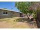 The backyard features a mature tree, landscaping and a neutral color scheme at 5029 W Osborn Rd, Phoenix, AZ 85031
