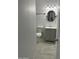 Charming half bath featuring a modern vanity, round mirror, and updated fixtures at 5029 W Osborn Rd, Phoenix, AZ 85031
