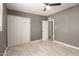 Bedroom featuring updated flooring, neutral paint, a ceiling fan, closet, and new doors at 5029 W Osborn Rd, Phoenix, AZ 85031