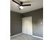 Cozy bedroom with ceiling fan, gray walls, and light-colored floors at 5029 W Osborn Rd, Phoenix, AZ 85031
