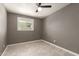 Bedroom with light tile flooring, ceiling fan, neutral paint, and updated window at 5029 W Osborn Rd, Phoenix, AZ 85031