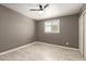 Bedroom with light tile flooring, ceiling fan, neutral paint, window, and closet at 5029 W Osborn Rd, Phoenix, AZ 85031
