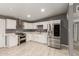 Newly renovated kitchen with stainless steel appliances, double oven, white cabinetry, and modern fixtures at 5029 W Osborn Rd, Phoenix, AZ 85031