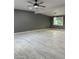 Large open-concept living space with gray walls, contemporary lighting, and modern floors at 5029 W Osborn Rd, Phoenix, AZ 85031