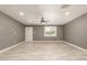 Open-concept living room features tile floors, ceiling fan, brick accent wall, and natural light from a window at 5029 W Osborn Rd, Phoenix, AZ 85031