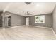 Spacious living room showcasing light tile floors, a modern ceiling fan and recessed lighting at 5029 W Osborn Rd, Phoenix, AZ 85031
