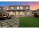 This spacious backyard features manicured lawn, cozy fire pit, and covered outdoor dining area at 5661 S Dante --, Mesa, AZ 85212