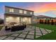 A vast backyard is complete with manicured lawn, cozy fire pit and covered outdoor dining area at 5661 S Dante --, Mesa, AZ 85212