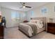 A serene bedroom with neutral tones, a comfortable bed, and ample natural light creating a calming retreat at 5661 S Dante --, Mesa, AZ 85212