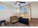 Bedroom room featuring two cribs, a dresser with changing pad, and ample natural light at 5661 S Dante --, Mesa, AZ 85212
