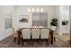 An elegantly staged dining area with modern chandelier, a wooden table, and stylish seating for a welcoming atmosphere at 5661 S Dante --, Mesa, AZ 85212