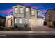 Stunning two-story home showcases manicured landscaping, a welcoming entrance, and a brick driveway at 5661 S Dante --, Mesa, AZ 85212