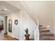 Bright foyer featuring a staircase with carpeted steps and white railings, plus decorative elements at 5661 S Dante --, Mesa, AZ 85212