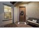 Charming home entrance featuring a wooden front door with a wreath, plus a bench and window at 5661 S Dante --, Mesa, AZ 85212