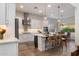 Modern kitchen with white cabinetry, stainless steel appliances, and a large center island with seating at 5661 S Dante --, Mesa, AZ 85212