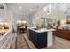 Modern kitchen with a large island, stainless steel appliances, and an open floor plan concept to the living room at 5661 S Dante --, Mesa, AZ 85212