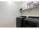 Convenient laundry room with new front-loading washer and dryer, plus storage shelves at 5661 S Dante --, Mesa, AZ 85212