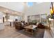 Open-concept living space featuring kitchen, dining, and living areas, with a large leather sofa and high ceilings at 5661 S Dante --, Mesa, AZ 85212