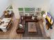 A birds eye view of an open-concept living space with a modern kitchen, dining area, and a spacious living room at 5661 S Dante --, Mesa, AZ 85212