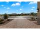 Street view of the neighborhood, showcasing well-maintained homes under a partly cloudy sky at 5661 S Dante --, Mesa, AZ 85212