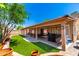 Inviting backyard with a covered patio, artificial turf, and a built-in barbecue area, perfect for outdoor gatherings at 5912 W Gail Dr, Chandler, AZ 85226