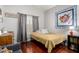 Cozy bedroom with hardwood floors, neutral-colored walls, and a window with shutter style blinds at 5912 W Gail Dr, Chandler, AZ 85226