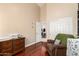 Light-filled Bedroom with closet, dresser and brown chair with hardwood floors at 5912 W Gail Dr, Chandler, AZ 85226