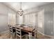 Well-lit dining room featuring a wood table, chandelier, and shuttered windows, creating an inviting atmosphere at 5912 W Gail Dr, Chandler, AZ 85226