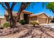 Charming home with desert landscaping, mature trees, and a convenient three-car garage at 5912 W Gail Dr, Chandler, AZ 85226