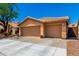 Three-car garage home with a tile roof and desert landscaping at 5912 W Gail Dr, Chandler, AZ 85226