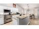 Bright kitchen featuring white cabinets, granite countertops, a large island, and stainless steel appliances at 5912 W Gail Dr, Chandler, AZ 85226