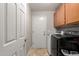 Laundry room with wooden cabinets and a modern washer and dryer at 5912 W Gail Dr, Chandler, AZ 85226