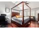 Main bedroom with a four-poster bed, hardwood floors, and a ceiling fan for a comfortable, inviting space at 5912 W Gail Dr, Chandler, AZ 85226