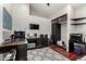 A modern home office with desk, a TV, and storage shelving at 5912 W Gail Dr, Chandler, AZ 85226