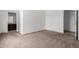 Spacious bedroom featuring neutral carpet, base trim and an en suite bathroom at 6320 S 26Th Dr, Phoenix, AZ 85041